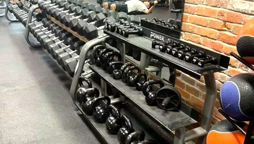 Free-weight area with dumbbell racks and benches.